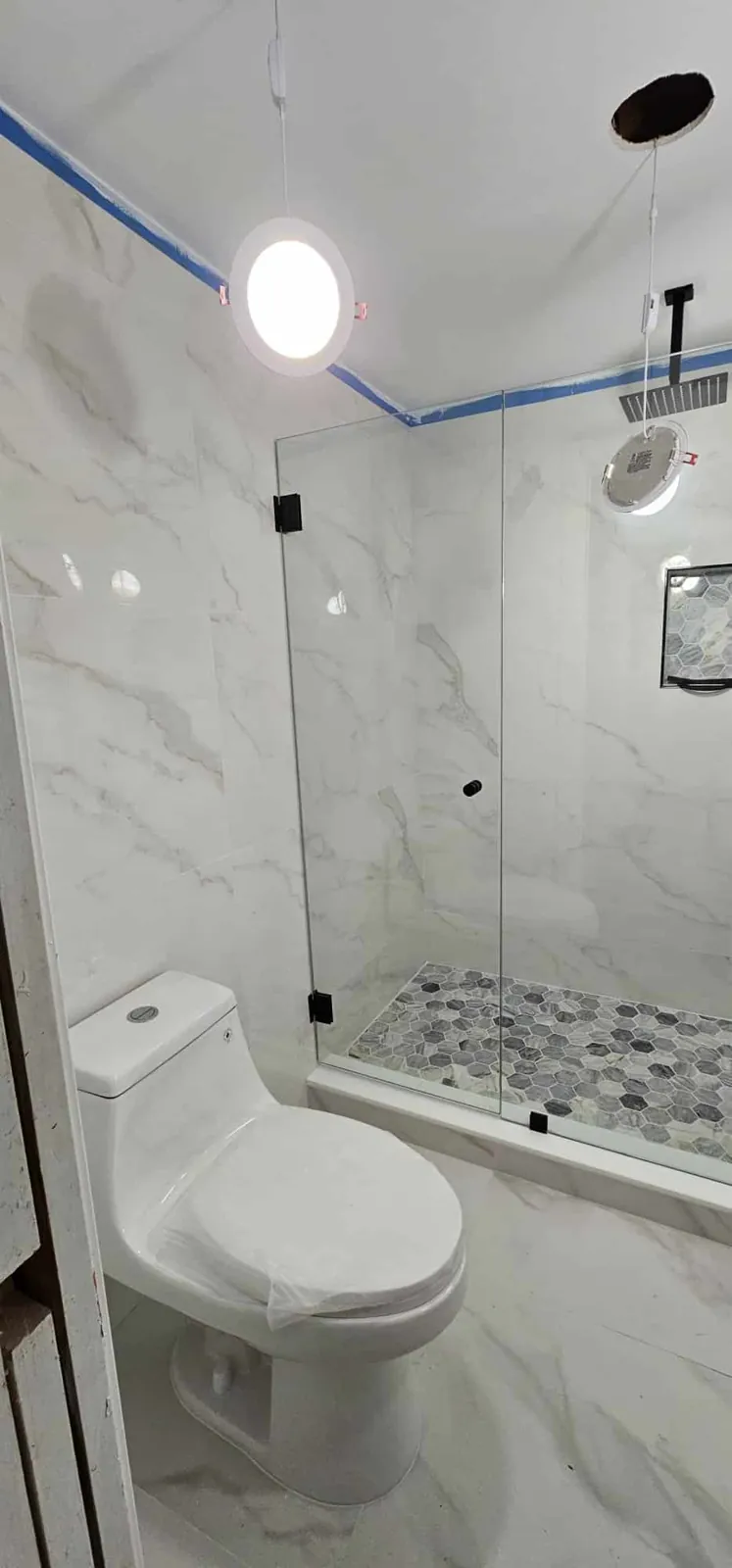 Finished bathroom remodel by Global Contractors with a frameless glass shower
