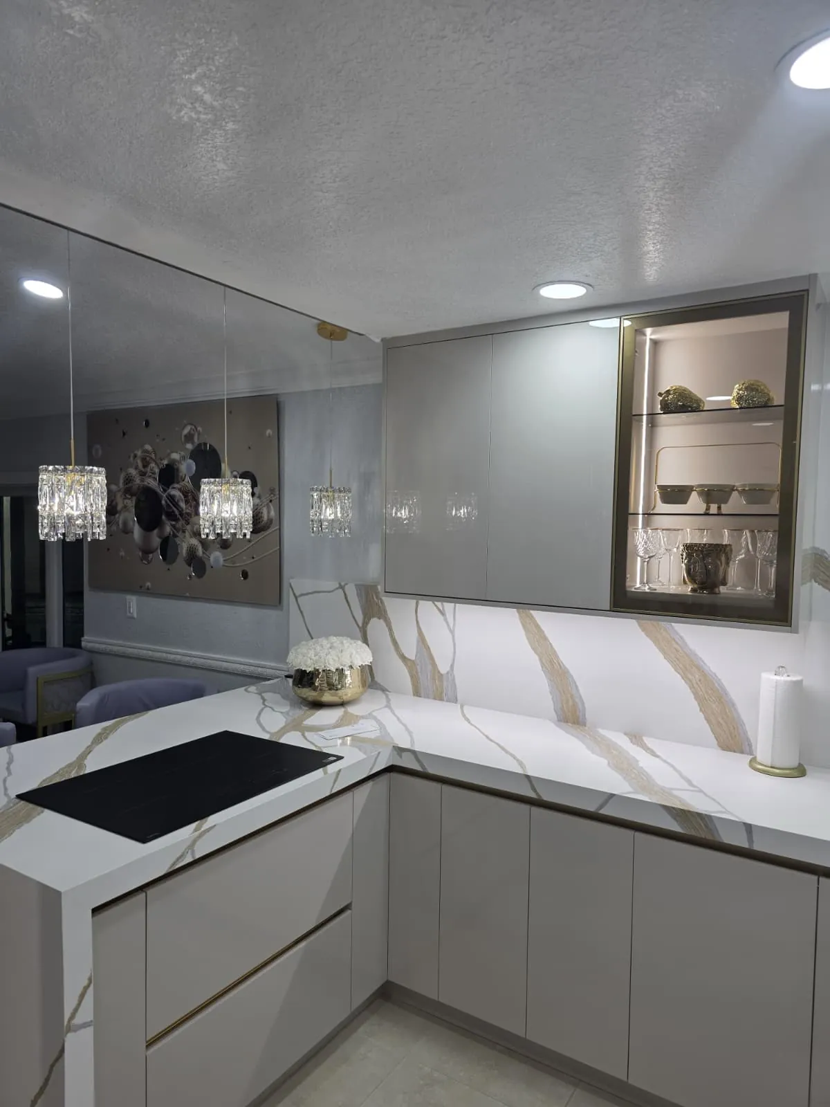 Finished kitchen with marble-look quartz countertops and backsplash
