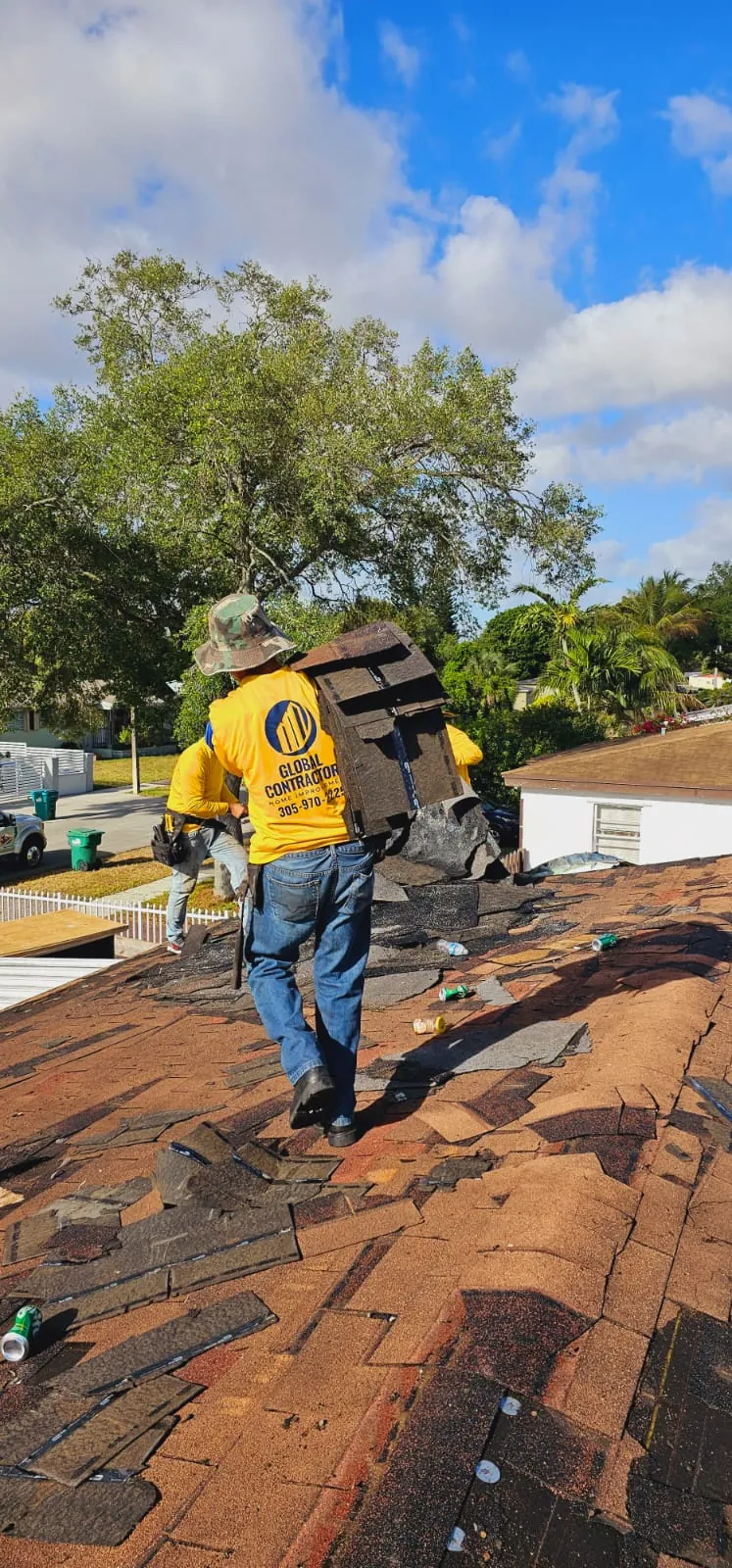 Cuadrilla de Global Contractors quitando un techo de shingle viejo